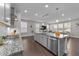 Open-concept kitchen with granite countertops, stainless steel appliances, and seamless flow to the living room at 4009 Reunion Creek Pkwy, Apex, NC 27539