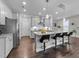 Modern kitchen with stainless steel appliances, a large island with bar seating, and ample counter space at 4009 Reunion Creek Pkwy, Apex, NC 27539