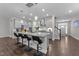 Stylish kitchen featuring a large island with barstool seating, pendant lighting, and modern gray cabinetry at 4009 Reunion Creek Pkwy, Apex, NC 27539