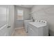 Functional laundry room with modern appliances, storage shelves, and a bright window at 4009 Reunion Creek Pkwy, Apex, NC 27539