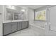 Bright Primary bathroom with double vanity, soaking tub, and separate glass-enclosed shower at 4009 Reunion Creek Pkwy, Apex, NC 27539
