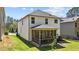 A well-kept white house has a screened-in porch and a green backyard at 4009 Reunion Creek Pkwy, Apex, NC 27539