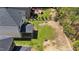 This aerial shot showcases a home with a screened porch and a manicured lawn at 4009 Reunion Creek Pkwy, Apex, NC 27539