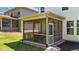 This is a cozy screened-in porch featuring brick flooring, a wooden railing, and natural light at 4009 Reunion Creek Pkwy, Apex, NC 27539