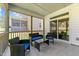 Relaxing screened porch features stylish wicker furniture with blue cushions and views of the backyard at 4009 Reunion Creek Pkwy, Apex, NC 27539