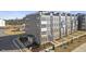 Modern townhome exterior features multiple levels, neutral exteriors, and sidewalks near developing community at 408 Gaston Park Ln # 100, Wake Forest, NC 27587
