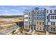 New modern townhomes feature multiple levels, roof decks, and neutral exteriors near a developing neighborhood at 408 Gaston Park Ln # 100, Wake Forest, NC 27587