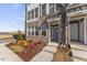 Modern townhome brick exterior and entrance features landscaped garden, concrete walkway and visible house numbers at 408 Gaston Park Ln # 100, Wake Forest, NC 27587