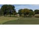 Scenic view of a well-maintained golf course with lush green grass, trees, and a serene lake at 408 Gaston Park Ln # 100, Wake Forest, NC 27587