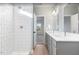 Bathroom featuring dual vanity, glass shower, and tile walls at 425 Longfellow St, Fuquay Varina, NC 27526
