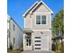 Charming two-story home featuring a modern garage door, stylish gray siding, and a welcoming front entrance at 431 Longfellow St, Fuquay Varina, NC 27526