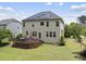 Aerial view of a home with solar panels on the roof, a wooden deck, and a green lawn at 449 Sandy Whispers Pl, Cary, NC 27519