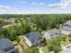 Aerial view of a beautiful home with solar panels, and lush green surroundings at 449 Sandy Whispers Pl, Cary, NC 27519