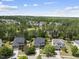 An aerial view of a residential area showing beautiful homes and wooded surroundings at 449 Sandy Whispers Pl, Cary, NC 27519