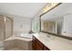Bright bathroom features a soaking tub, separate shower, and spacious vanity with large mirror at 449 Sandy Whispers Pl, Cary, NC 27519