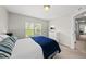 Bedroom with plush carpeting, a queen bed, dresser and plenty of natural light at 449 Sandy Whispers Pl, Cary, NC 27519
