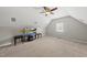 An upstairs bonus room features a ceiling fan and a TV atop a wooden stand on a carpeted floor at 449 Sandy Whispers Pl, Cary, NC 27519