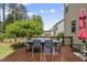 Enjoy outdoor dining on the wooden deck, surrounded by lush greenery, perfect for relaxation and entertaining at 449 Sandy Whispers Pl, Cary, NC 27519