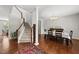 Elegant dining area with hardwood floors, staircase, chandelier, and space for entertaining guests at 449 Sandy Whispers Pl, Cary, NC 27519