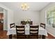 Formal dining room featuring hardwood floors, natural light, and space for comfortable Gathering dinners at 449 Sandy Whispers Pl, Cary, NC 27519