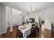 Formal dining room featuring hardwood floors, natural light, columns, and space for comfortable Gathering dinners at 449 Sandy Whispers Pl, Cary, NC 27519