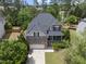 An aerial view showing a stunning two-story home with a stone facade and well-manicured lawn at 449 Sandy Whispers Pl, Cary, NC 27519