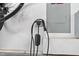 Garage showcasing a vehicle charging point and a bicycle wheel, promoting eco-friendly transportation options at 449 Sandy Whispers Pl, Cary, NC 27519