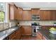 Well-equipped kitchen with stainless steel appliances, granite countertops, and abundant cabinet space at 449 Sandy Whispers Pl, Cary, NC 27519