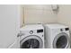 A clean laundry room with a front-load washer and dryer set, enhancing convenience and efficiency at 449 Sandy Whispers Pl, Cary, NC 27519