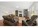 Inviting living room with hardwood floors, fireplace, built-in bookshelves, and lots of natural light at 449 Sandy Whispers Pl, Cary, NC 27519