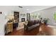 Comfortable living room with hardwood floors, fireplace, built-in bookshelves, and lots of natural light at 449 Sandy Whispers Pl, Cary, NC 27519