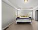 Large main bedroom with tray ceiling, neutral walls, carpet, bedside tables, and two windows with blinds at 449 Sandy Whispers Pl, Cary, NC 27519