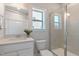 Clean bathroom featuring a glass shower, window, and single vanity with neutral wall coloring at 45 Addison Pond Ct # 11, Zebulon, NC 27597