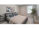 Inviting bedroom with a view, a stylish lamp, and comfortable bedding at 45 Addison Pond Ct # 11, Zebulon, NC 27597