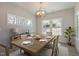 Inviting dining room with modern chandelier, ample natural light, and seating for six at 45 Addison Pond Ct # 11, Zebulon, NC 27597