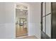 Inviting entryway with light wood floors leading into a spacious living area with white wainscoting and natural light at 45 Addison Pond Ct # 11, Zebulon, NC 27597