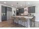 Spacious kitchen with a large island, gray cabinets, and modern pendant lighting fixtures at 45 Addison Pond Ct # 11, Zebulon, NC 27597