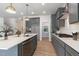 Modern kitchen featuring gray cabinets, quartz countertops, and stainless steel appliances at 45 Addison Pond Ct # 11, Zebulon, NC 27597
