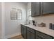Butler's pantry with gray cabinets, quartz countertops and brushed gold hardware and decor at 45 Addison Pond Ct # 11, Zebulon, NC 27597
