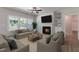 Bright living room with fireplace, large windows, neutral furniture and open floorplan at 45 Addison Pond Ct # 11, Zebulon, NC 27597
