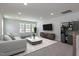 Cozy living room with plush sofa, modern decor, and plenty of natural light at 45 Addison Pond Ct # 11, Zebulon, NC 27597