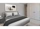 Comfortable main bedroom showcasing neutral tones, framed wall art, and a minimalist design aesthetic at 45 Addison Pond Ct # 11, Zebulon, NC 27597