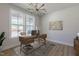 Bright home office featuring modern desk, stylish lighting, and large windows offering neighborhood views at 45 Addison Pond Ct # 11, Zebulon, NC 27597