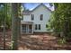 View of the backyard featuring a screen porch and a white exterior of the two-story home at 4500 Hollirose Pl, Raleigh, NC 27616
