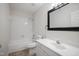 Bright bathroom with a shower-tub combo and a white vanity at 4500 Hollirose Pl, Raleigh, NC 27616