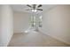 Cozy bedroom with carpet flooring, ceiling fan and two windows with treed views at 4500 Hollirose Pl, Raleigh, NC 27616