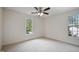 Bright bedroom with carpet, ceiling fan, and natural light from the windows at 4500 Hollirose Pl, Raleigh, NC 27616