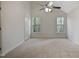 Spacious bedroom featuring vaulted ceilings and natural light from the large windows at 4500 Hollirose Pl, Raleigh, NC 27616