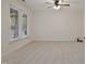 Spacious bedroom featuring neutral carpet, a ceiling fan, and a large window at 4500 Hollirose Pl, Raleigh, NC 27616