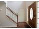 Open entryway showcases wood floors, staircase, and wood door leading to a second floor at 4500 Hollirose Pl, Raleigh, NC 27616